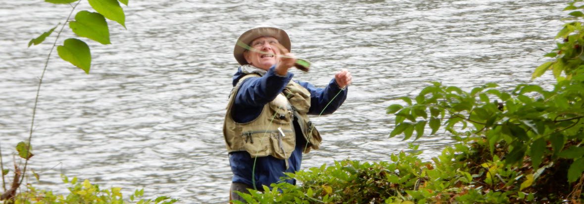 best fishing vests - man casting wearing vest
