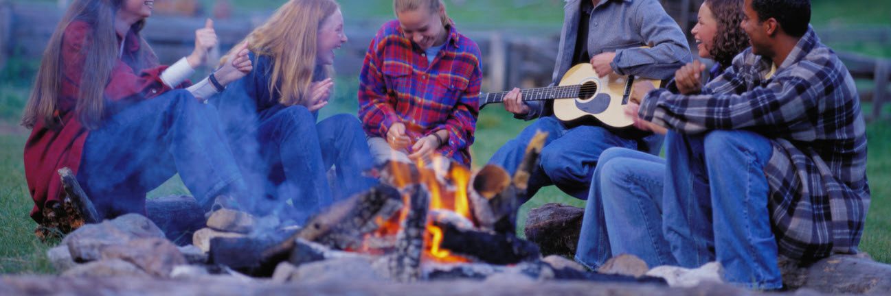 tips for campfire safety - family around campfire