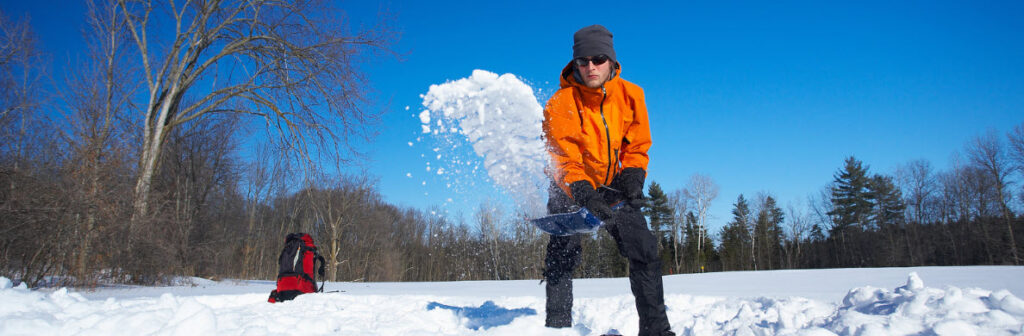 Best camping shovel multikits - man shoveling snow