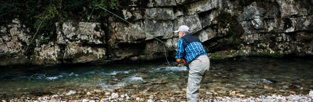 best fly fishing combos for beginners - man fly fishing in stream
