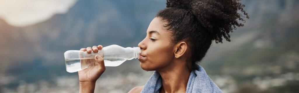 best water purifiers for camping - girl drinking water