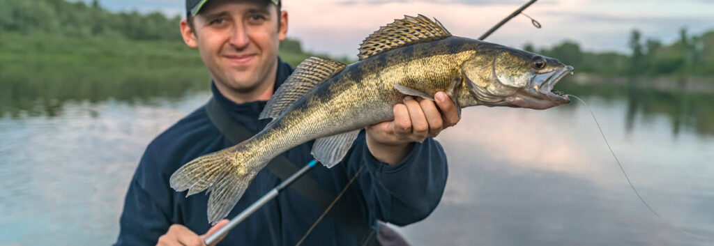 rod and reel combos for walleye - man with Walleye
