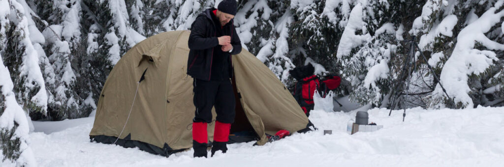 How To Heat A Tent Safely - man camping in snow