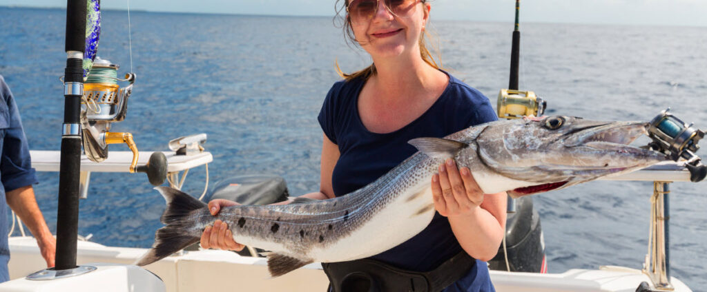 tips for deep sea trolling - woman holding mackerel