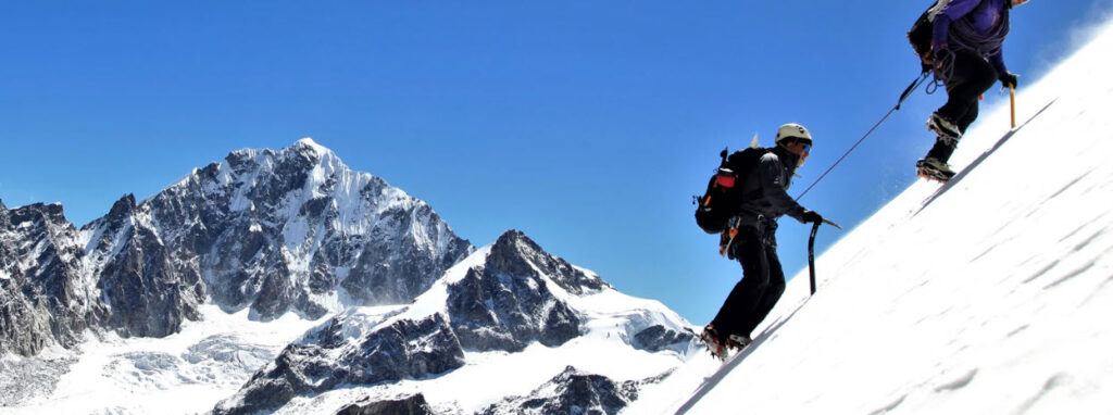 mountaineering boots - men climbing snow slope