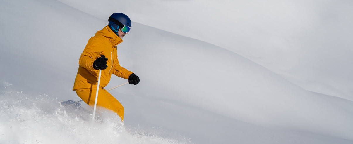 best ski suits for men - man snow skiing