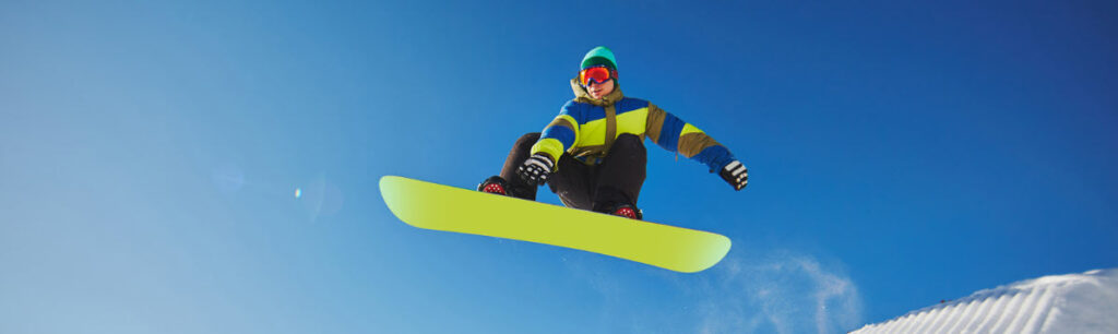 best ski suits for men - man snowboarding